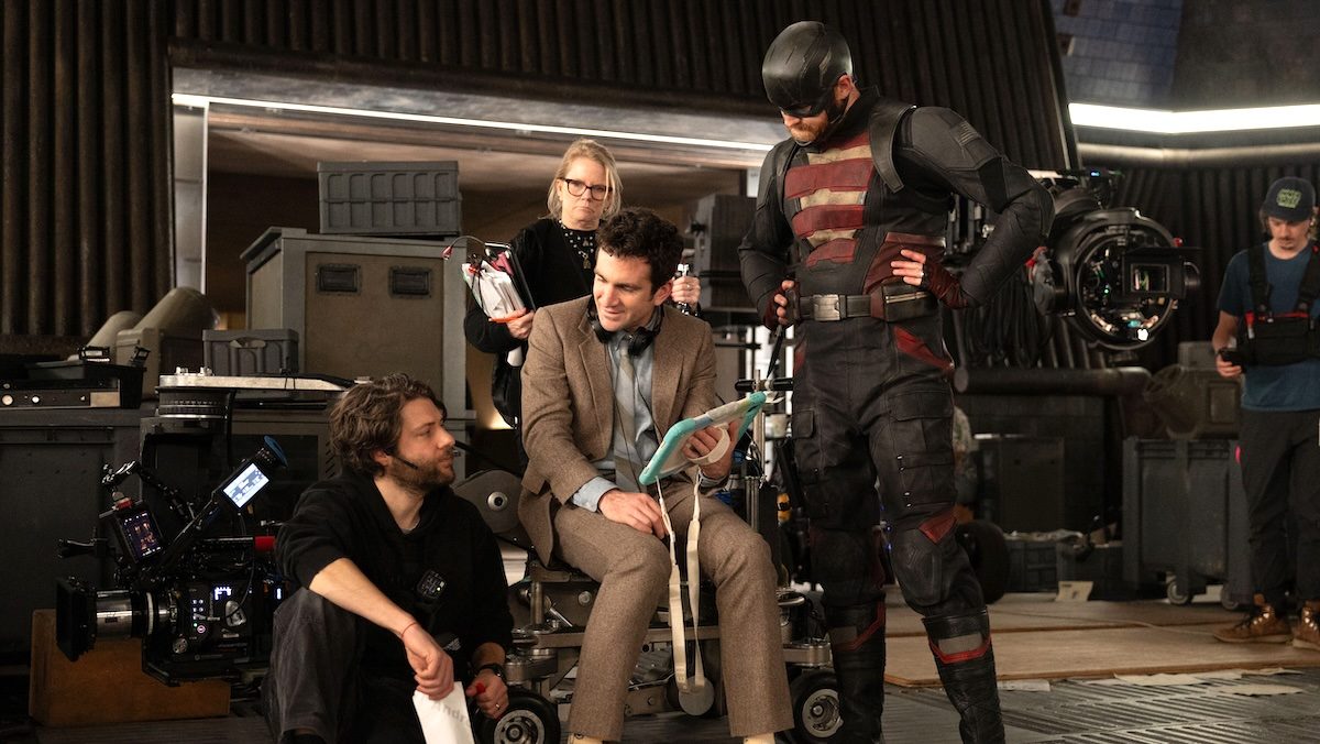 Director Jake Schreier sits while giving notes to cast and crew on Thunderbolts