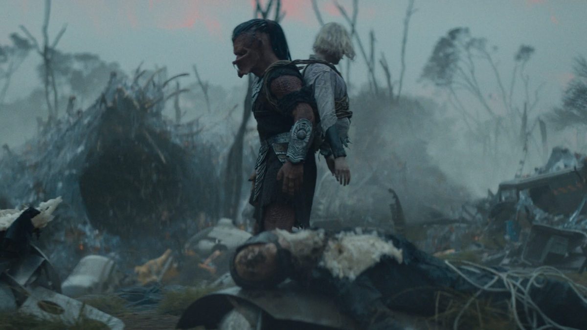 Dek walks around with android Elle Fanning on his back.
