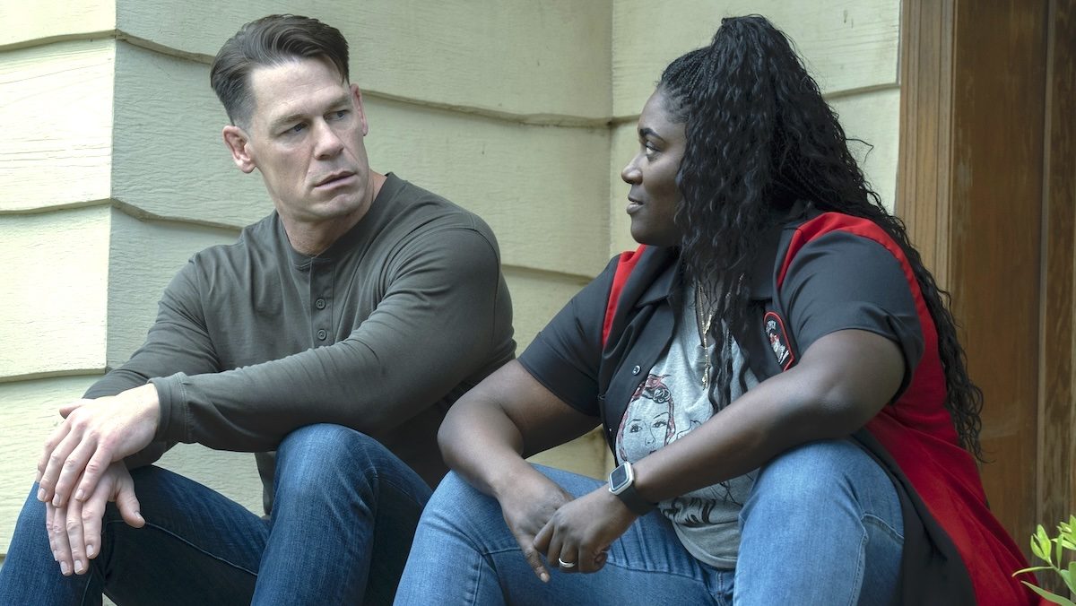 John Cena and Danielle Brooks sittingon steps on Peacemaker