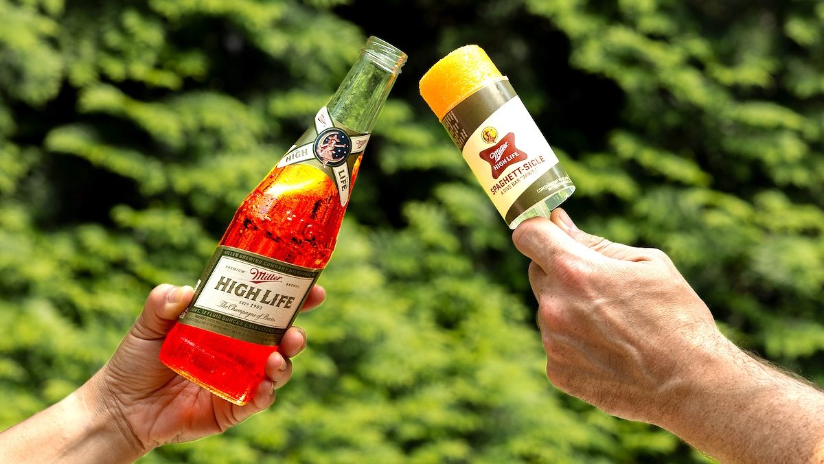 A Milelr High Life toasting with a push pop ice cream made by Miller High Life, the Spaghett-sicle