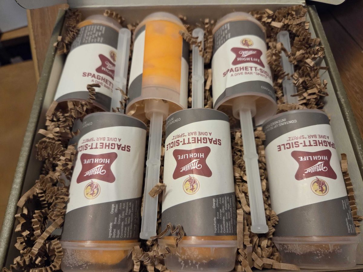 Six orange Miller High Life Spaghett-sicle pops inside the open box