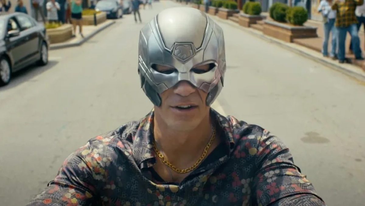 Peacemaker drives his motorcycle in the alternate universe.