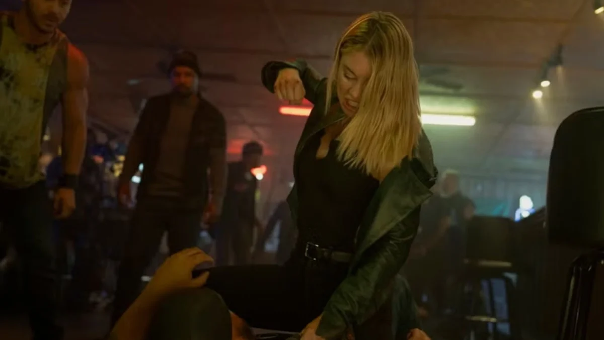 Jennifer Holland as Emilia Harcourt in a brutal bar fight in Peacemaker season two.