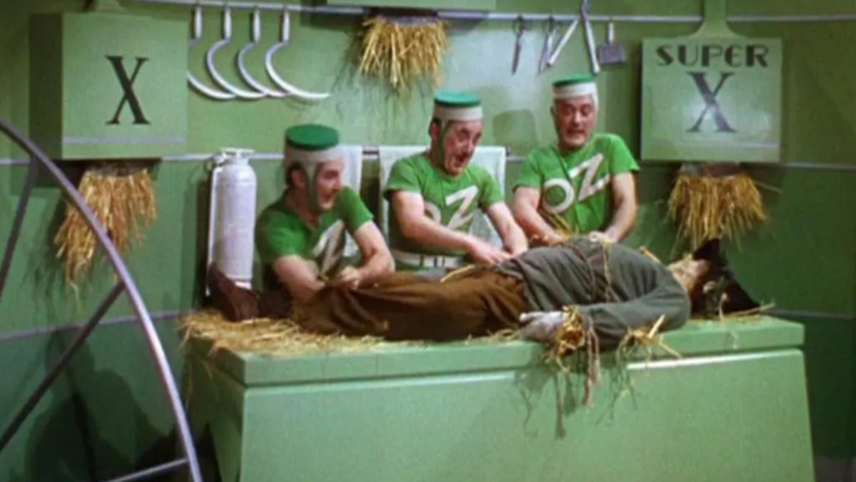 The Emerald City employees with Oz t-shirts in The Wizard of Oz.