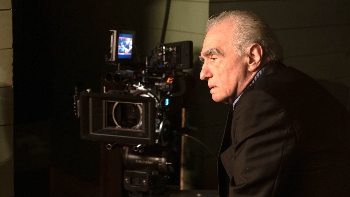 Martin Scorsese in profile near a movie camera