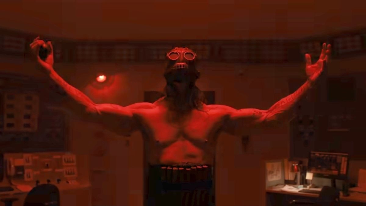 image of man wearing a mask and no shirt with his arms stretched wide in psycho killer trailer